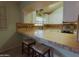 A bright kitchen featuring white cabinetry and a breakfast bar at 6546 N 71St Ave, Glendale, AZ 85303