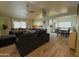 Bright, airy living room with wood-look floors, a ceiling fan and an open view to the dining area at 6546 N 71St Ave, Glendale, AZ 85303