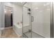 Modern bathroom with a glass-enclosed shower, a soaking tub and views of the walk-in closet at 6565 E Thomas Rd # 1128, Scottsdale, AZ 85251