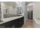 Modern bathroom with double sinks, sleek fixtures, and a glass-enclosed shower with white tile at 6565 E Thomas Rd # 1128, Scottsdale, AZ 85251