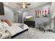Cozy bedroom with soft carpet, warm lighting, and a sliding barn door to the ensuite bathroom at 6565 E Thomas Rd # 1128, Scottsdale, AZ 85251