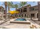 Inviting courtyard with a fountain, seating, and shade, surrounded by lush palm trees at 6565 E Thomas Rd # 1128, Scottsdale, AZ 85251