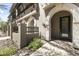 Inviting exterior entrance featuring a stone walkway, arched entryway, and manicured landscaping at 6565 E Thomas Rd # 1128, Scottsdale, AZ 85251