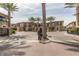 Inviting community entrance with palm trees and elegant townhome exteriors at 6565 E Thomas Rd # 1128, Scottsdale, AZ 85251