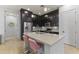 Bright and functional kitchen with stainless steel appliances, island, and dark wood cabinets at 6565 E Thomas Rd # 1128, Scottsdale, AZ 85251