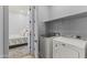 Laundry area next to the bedroom, featuring a Maytag washer, a dryer, and overhead shelving at 6565 E Thomas Rd # 1128, Scottsdale, AZ 85251