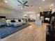 Open-concept living room with hardwood floors, ceiling fan and a sectional sofa at 6565 E Thomas Rd # 1128, Scottsdale, AZ 85251