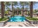 Resort-style pool surrounded by lush landscaping, palm trees, and plenty of seating for relaxation at 6565 E Thomas Rd # 1128, Scottsdale, AZ 85251