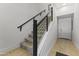Carpeted staircase featuring modern railings and leading to the upper levels of the home at 6565 E Thomas Rd # 1128, Scottsdale, AZ 85251
