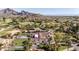 Luxury estate home with a backyard pool, Spanish tile roof, and meticulously maintained grounds next to a golf course at 7501 N Eucalyptus Dr, Paradise Valley, AZ 85253