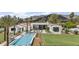 Expansive aerial view of luxurious home with a large pool, lush lawn, and mountain backdrop at 7501 N Eucalyptus Dr, Paradise Valley, AZ 85253