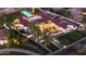 Aerial view of a luxury home with a backyard pool and meticulously maintained grounds, lit up at twilight at 7501 N Eucalyptus Dr, Paradise Valley, AZ 85253