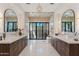 Lavish bathroom featuring dual vanities, tile flooring, and a frameless glass shower with designer fixtures at 7501 N Eucalyptus Dr, Paradise Valley, AZ 85253