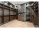 Expansive walk-in closet with ample shelving and drawers, complemented by stylish lighting at 7501 N Eucalyptus Dr, Paradise Valley, AZ 85253