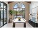 Bright dining room featuring a large window, modern light fixture, and elegant wood dining table at 7501 N Eucalyptus Dr, Paradise Valley, AZ 85253
