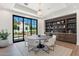 Bright dining room with a built-in bar area and a large window framing the manicured backyard at 7501 N Eucalyptus Dr, Paradise Valley, AZ 85253