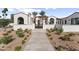 Elegant home with a gated entry, lush landscaping, and desert plants at 7501 N Eucalyptus Dr, Paradise Valley, AZ 85253