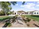 Stunning white stucco home with lush landscaping and a red tile roof under a blue sky at 7501 N Eucalyptus Dr, Paradise Valley, AZ 85253