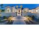 Home exterior at night with elegant lighting and a serene desert landscape at 7501 N Eucalyptus Dr, Paradise Valley, AZ 85253