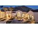 Charming home exterior at dusk, highlighting the beautifully landscaped yard, fire pit area, and architectural details at 7501 N Eucalyptus Dr, Paradise Valley, AZ 85253
