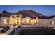 Stunning home exterior featuring lush landscaping, a cozy fire pit area, and beautiful architectural design against a mountain backdrop at 7501 N Eucalyptus Dr, Paradise Valley, AZ 85253
