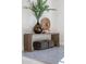 Artistic foyer with sleek console table, decorative accessories, and plush ottoman seating below at 7501 N Eucalyptus Dr, Paradise Valley, AZ 85253