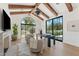 Bright home office with exposed beam vaulted ceilings and an arched window with views of the outdoors at 7501 N Eucalyptus Dr, Paradise Valley, AZ 85253