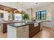 Modern kitchen with unique pendant lighting, large island, and seamless flow into living areas at 7501 N Eucalyptus Dr, Paradise Valley, AZ 85253