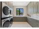 Well-equipped laundry room with modern appliances and ample cabinet space at 7501 N Eucalyptus Dr, Paradise Valley, AZ 85253