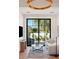 Cozy living room with floor-to-ceiling windows overlooking a manicured backyard and bright overhead lighting at 7501 N Eucalyptus Dr, Paradise Valley, AZ 85253