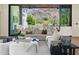 Bright living room featuring sliding glass doors with stunning views of the backyard and mountains in the distance at 7501 N Eucalyptus Dr, Paradise Valley, AZ 85253