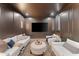 Cozy media room with a large screen TV, comfortable seating, and stylish decor at 7501 N Eucalyptus Dr, Paradise Valley, AZ 85253