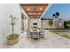 Inviting outdoor dining area with wood-covered ceiling, fan, and an extra long table, ideal for alfresco gatherings at 7501 N Eucalyptus Dr, Paradise Valley, AZ 85253