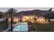 Luxury home's pool with lit landscaping, integrated spa, patio furniture, and elegant outdoor living space at twilight at 7501 N Eucalyptus Dr, Paradise Valley, AZ 85253