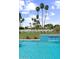 Inviting backyard pool area featuring an elegant waterfall feature, manicured lawn, and tropical palm trees at 7501 N Eucalyptus Dr, Paradise Valley, AZ 85253