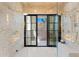 Luxurious shower featuring glass doors, dual shower heads, travertine walls, and white hexagon tile floors at 7501 N Eucalyptus Dr, Paradise Valley, AZ 85253