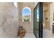 Stunning shower with travertine walls, a window, a marble bench, and sleek glass doors at 7501 N Eucalyptus Dr, Paradise Valley, AZ 85253