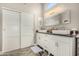 Bright bathroom featuring double sinks, modern fixtures, and elegant sliding door storage at 7810 W Beryl Ave, Peoria, AZ 85345