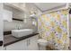Modern bathroom with vessel sink, floral shower curtain, and sleek fixtures at 7810 W Beryl Ave, Peoria, AZ 85345