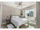 Cozy bedroom with a large window, comfortable bed, and views of the neighborhood at 7810 W Beryl Ave, Peoria, AZ 85345