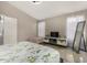 Bright bedroom featuring leafy-patterned bedding and lots of natural light from the windows at 7810 W Beryl Ave, Peoria, AZ 85345