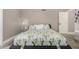 Relaxing bedroom with leafy patterned bedding, soft lighting and decor at 7810 W Beryl Ave, Peoria, AZ 85345