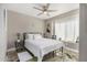 Comfortable bedroom featuring a large window, ceiling fan, and neutral decor at 7810 W Beryl Ave, Peoria, AZ 85345