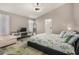 Comfortable bedroom features stylish decor, a ceiling fan, and plenty of natural light for a serene retreat at 7810 W Beryl Ave, Peoria, AZ 85345