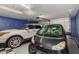 Well-organized garage with two cars parked inside, and storage area at 7810 W Beryl Ave, Peoria, AZ 85345