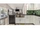 Bright kitchen with modern appliances, stainless steel sink, white cabinets and stylish backsplash at 7810 W Beryl Ave, Peoria, AZ 85345