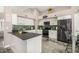 Modern kitchen featuring black appliances, white cabinets, dark counters and stylish backsplash at 7810 W Beryl Ave, Peoria, AZ 85345