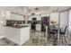 Spacious kitchen with stainless steel appliances, white cabinets, dark counters and stylish backsplash at 7810 W Beryl Ave, Peoria, AZ 85345