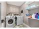 Functional laundry room with modern washer and dryer, shelving and ample storage at 7810 W Beryl Ave, Peoria, AZ 85345