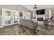 Cozy living room with a fireplace, plush seating, and backyard access via French doors at 7810 W Beryl Ave, Peoria, AZ 85345